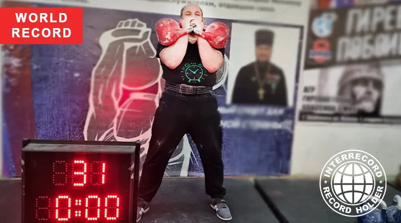 Наибольшее количество толчков двух гирь весом 32 кг за одну минуту