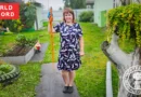 Marina Matveeva holding the longest carrot grown in Russia