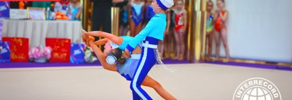 sibling duo performing rhythmic gymnastics routine