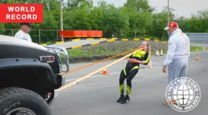 Liudmila Spirina pulling a 3105 kg Hummer H2 with her teeth