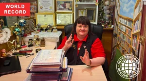 Irina Aleksandrova holding her education diplomas