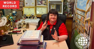 Irina Aleksandrova holding her education diplomas