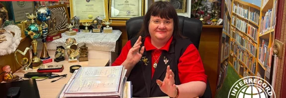 Irina Aleksandrova holding her education diplomas