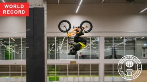 Young BMX athlete completing a double backflip with a stable landing
