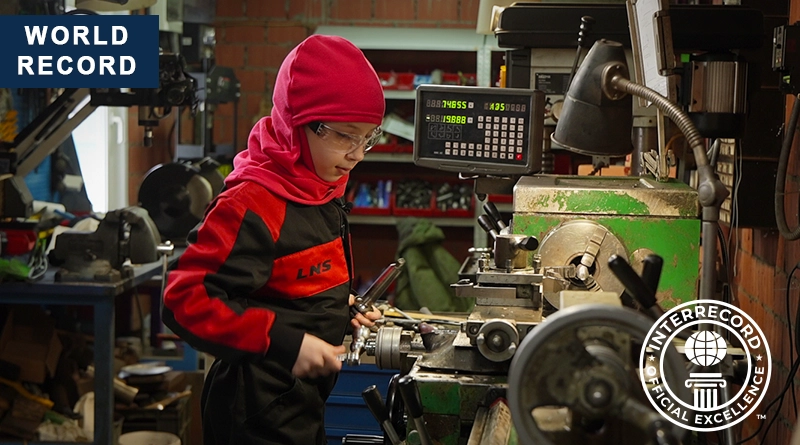 The youngest girl turner Elizaveta Altunina working on an industrial lathe
